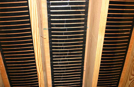 Installing heating element between floor joists.