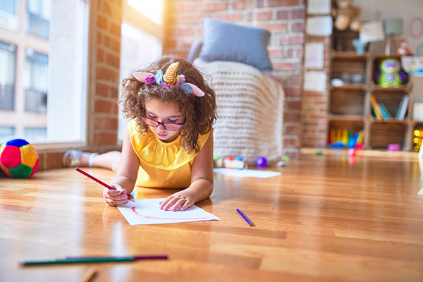 Child on a warm hardwood floor.